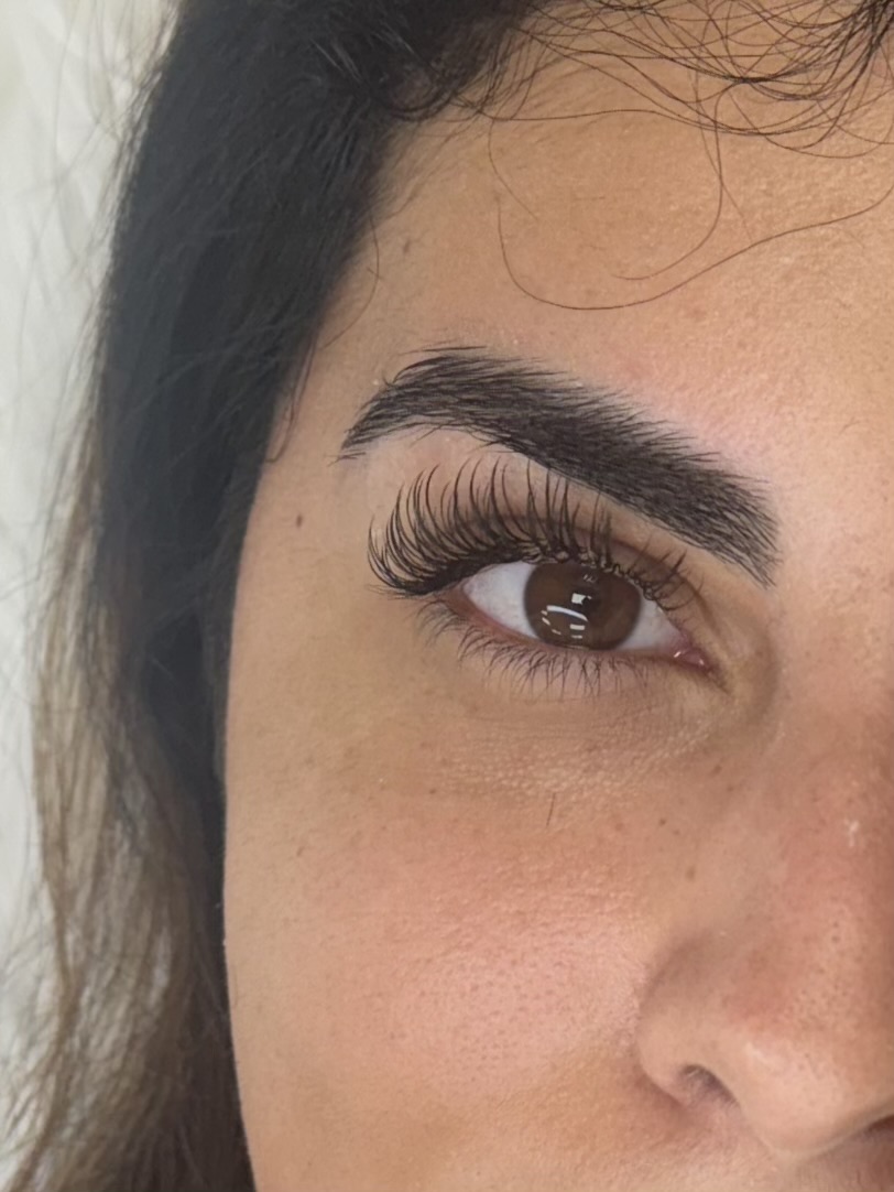 Lash extensions and brow shaping - close up brow and eye detail